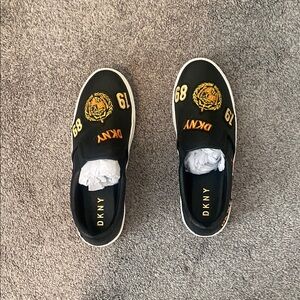 DKNY Black Slip-On Sneakers with Gold Accents